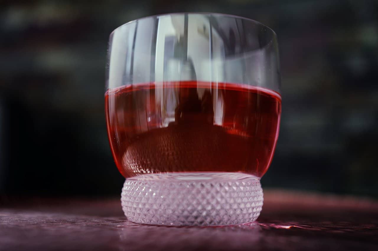 Hibiscus Herbal Tea Deep Red Beverage Textured Glass Closeup Refreshing Drink - integrative healthcare treatment at Healers Clinic Dubai