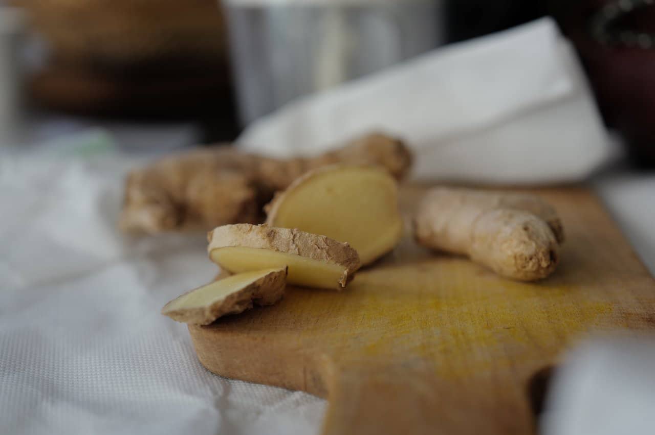 Fresh Ginger Root Slices Wooden Cutting Board Preparation Cooking - integrative healthcare treatment at Healers Clinic Dubai