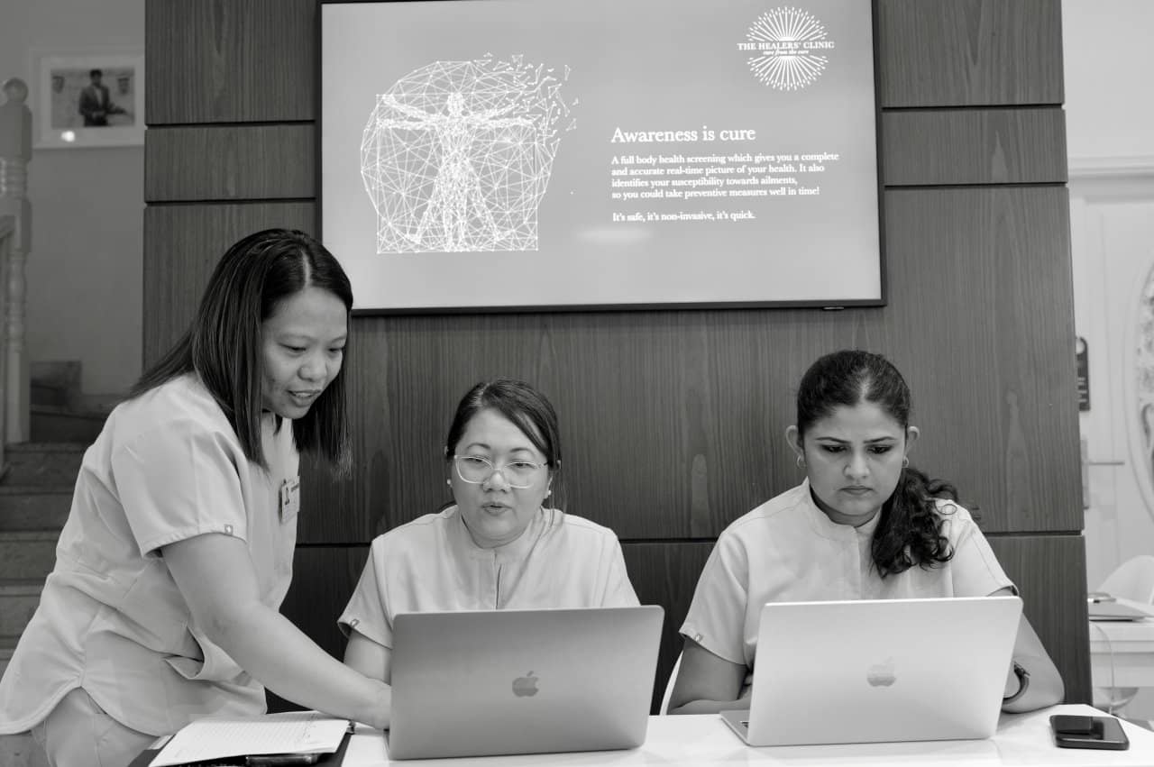 Healers Clinic Staff Nurses Laptop Work Team Administration - our qualified healthcare team at Healers Clinic Dubai