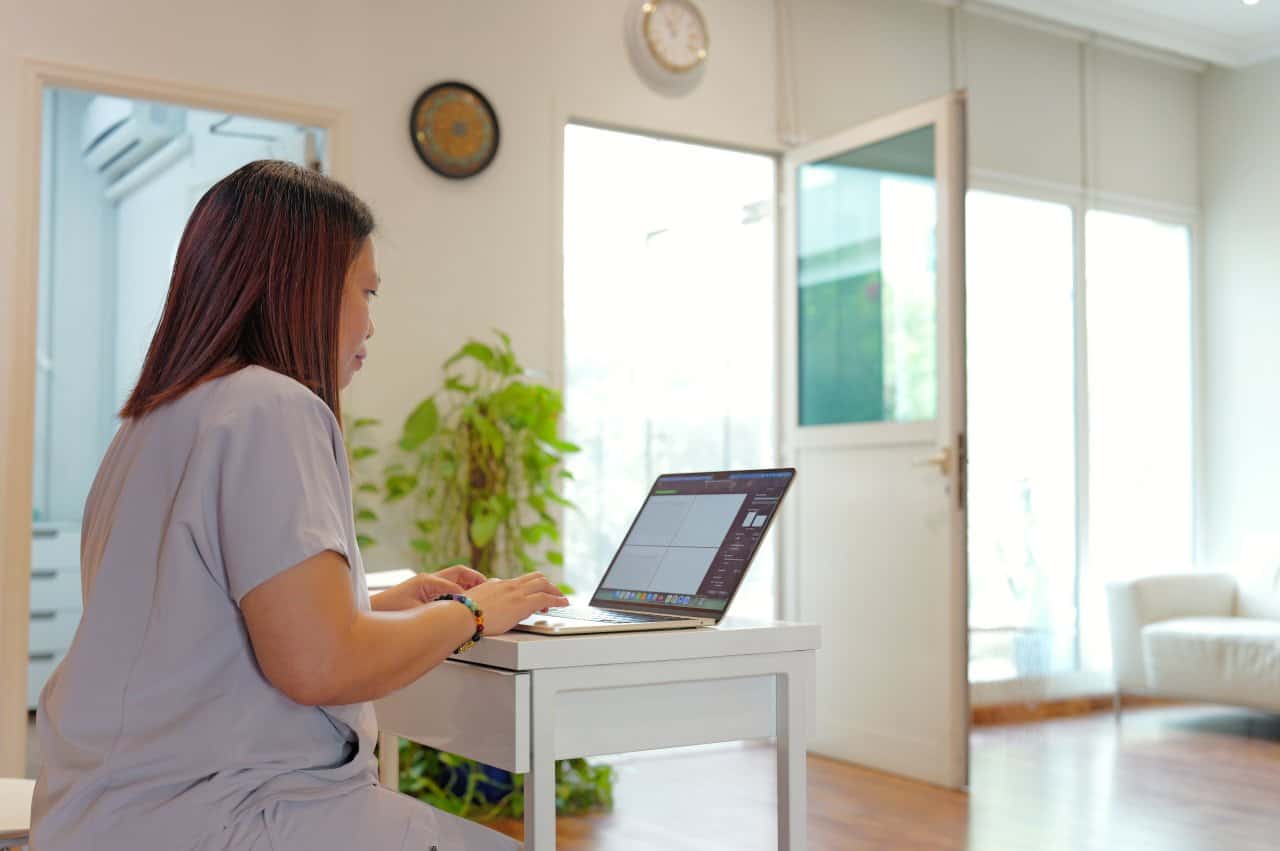 Healthcare Professional Scrubs Laptop Clinic Office Administration - our qualified healthcare team at Healers Clinic Dubai