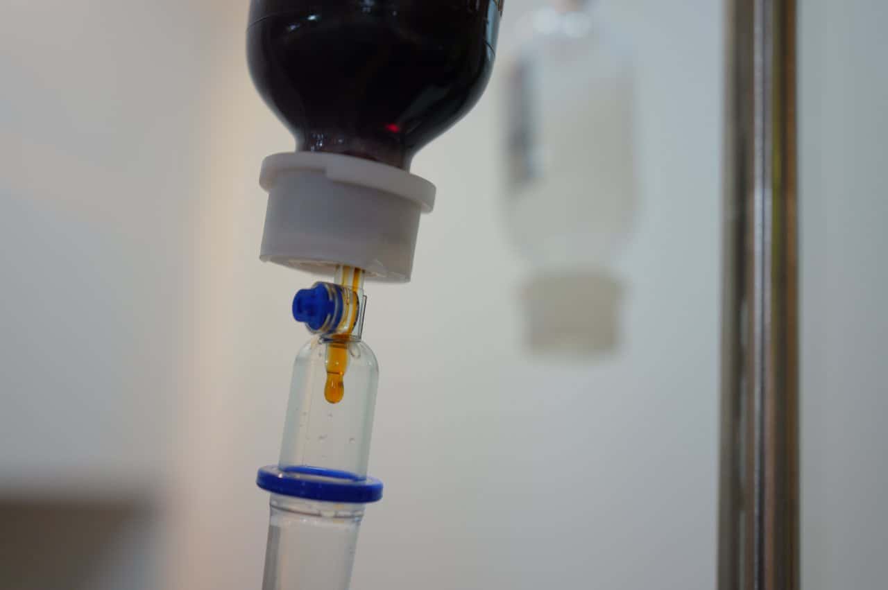 Iv Infusion Dark Amber Liquid Medication Port Tubing Clinic Treatment - integrative healthcare treatment at Healers Clinic Dubai