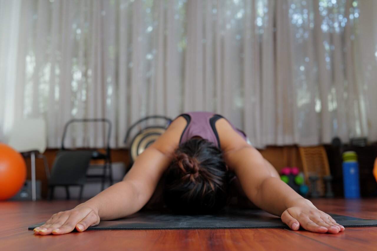 Yoga Childs Pose Balasana Practitioner Purple Top Studio Relaxation - integrative healthcare treatment at Healers Clinic Dubai
