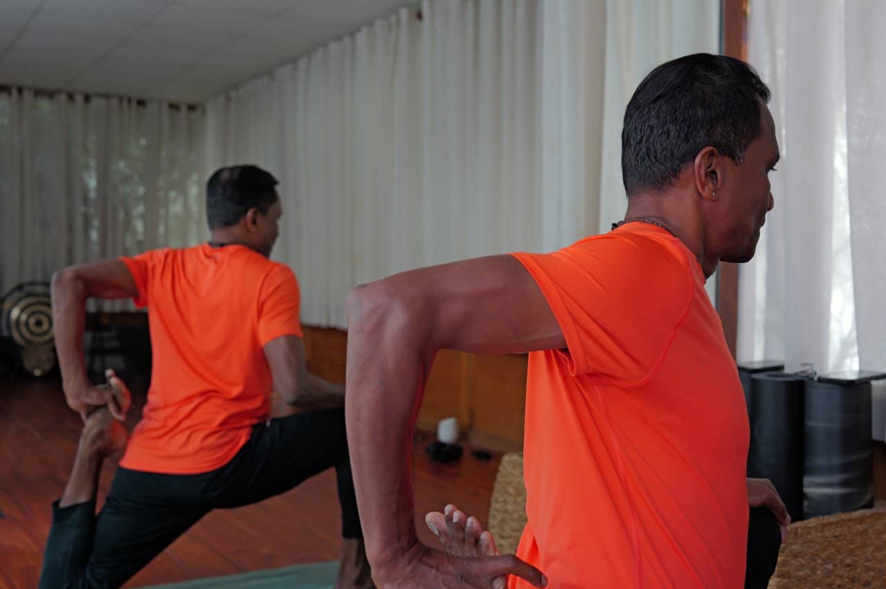 Yoga Revolved Triangle Pose Parivrtta Trikonasana Bind Orange Studio - integrative healthcare treatment at Healers Clinic Dubai